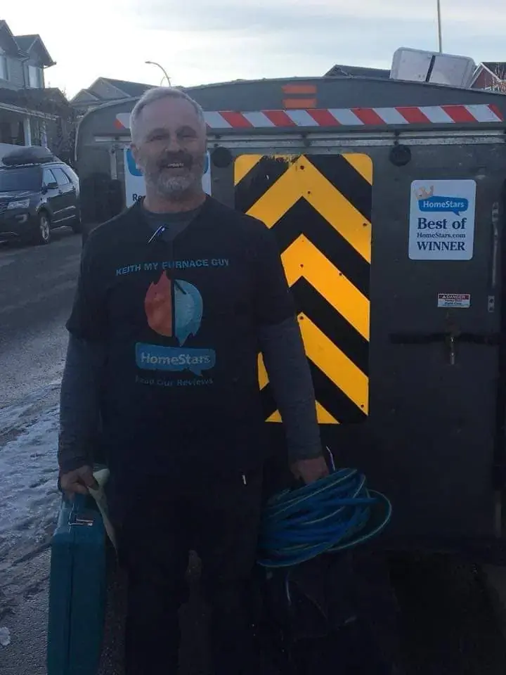 Keith Last working on furnace maintenance